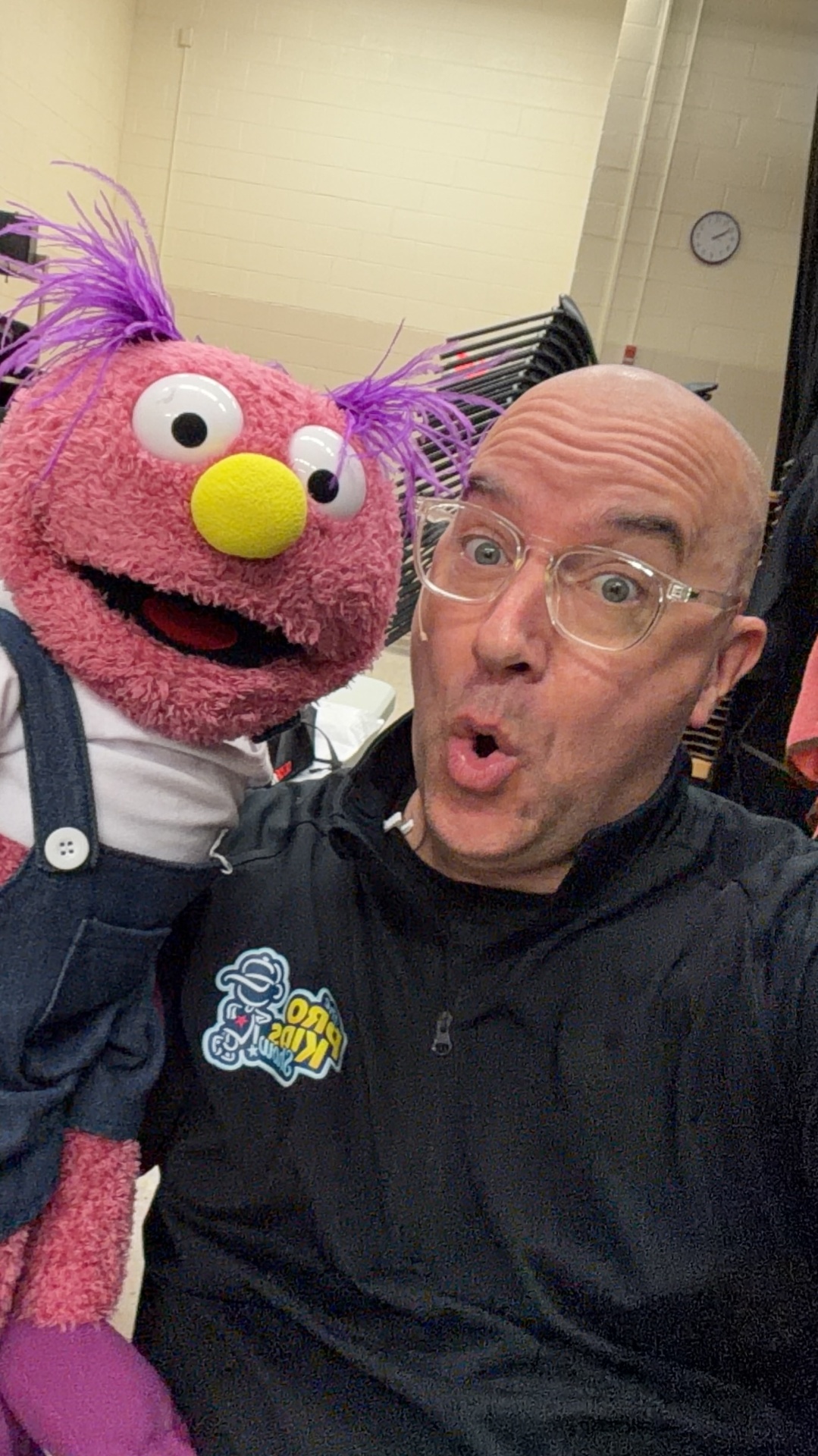Tim backstage at Scott Elementary with a puppet before the show