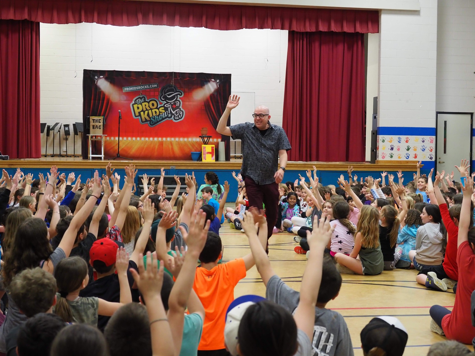 Students cheering at a Pro-Kids Show assembly