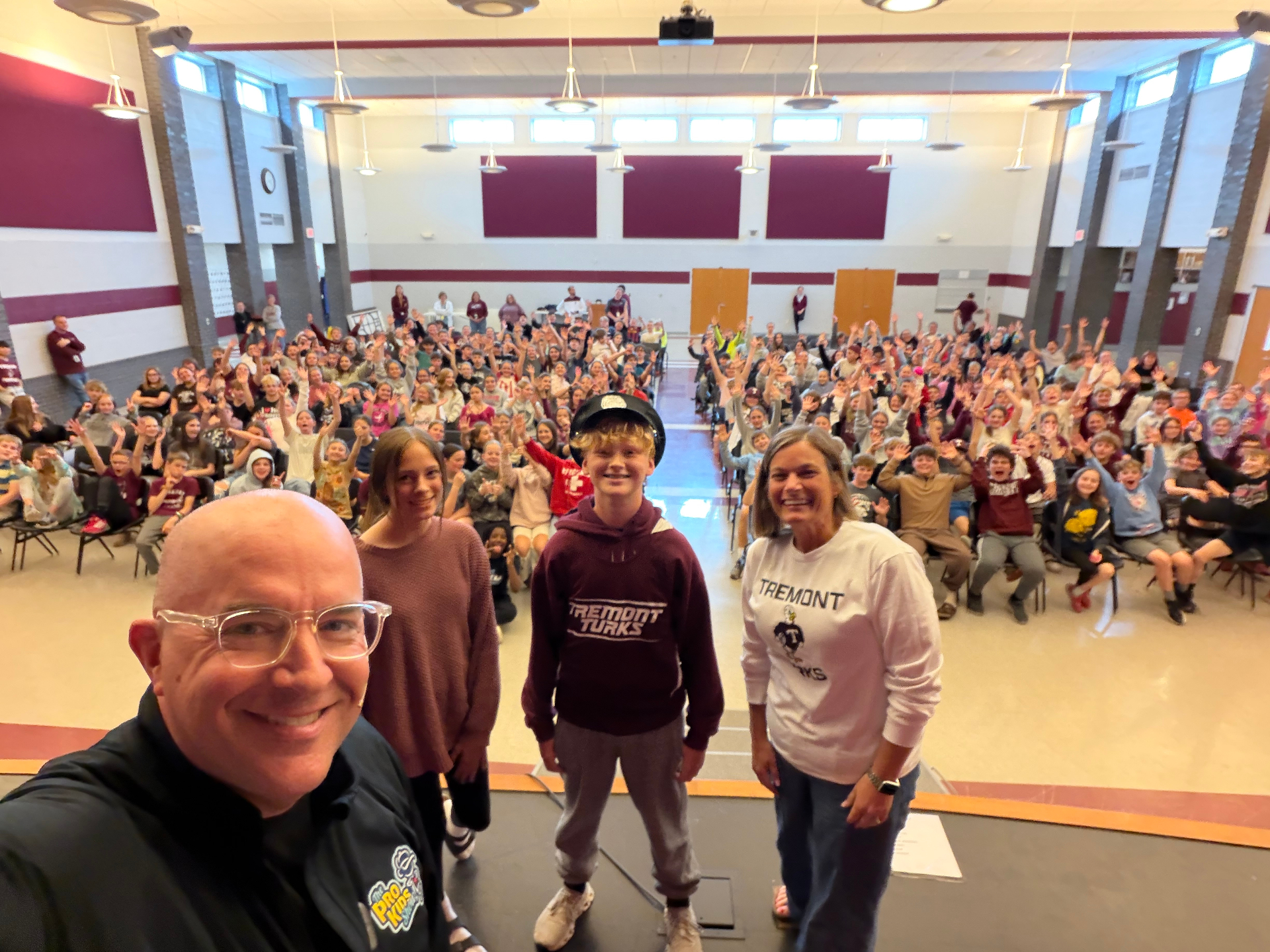 Tim taking a selfie with the Tremont Turks in a packed auditorium