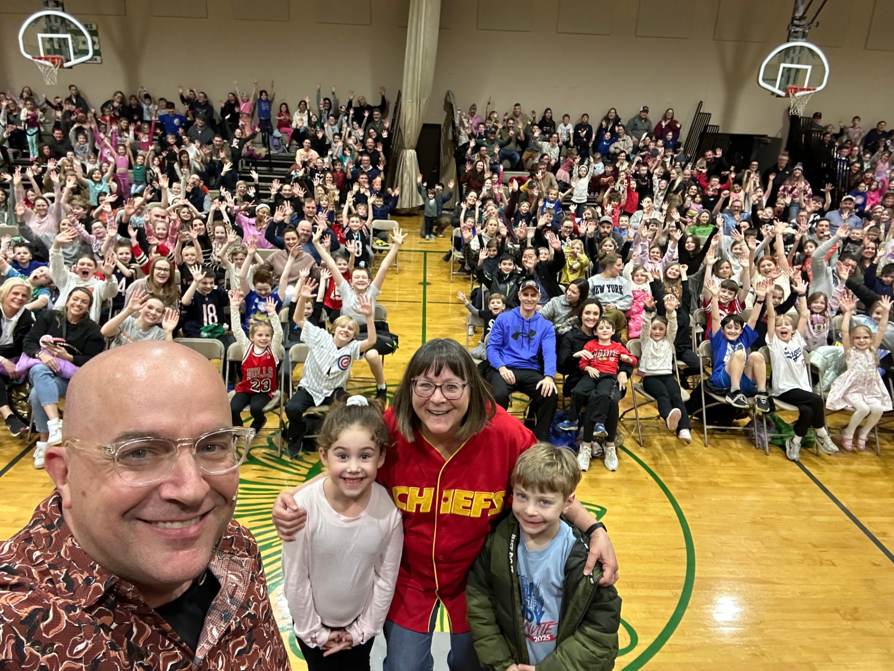 Catholic school family night show with the principal on stage after a fun routine