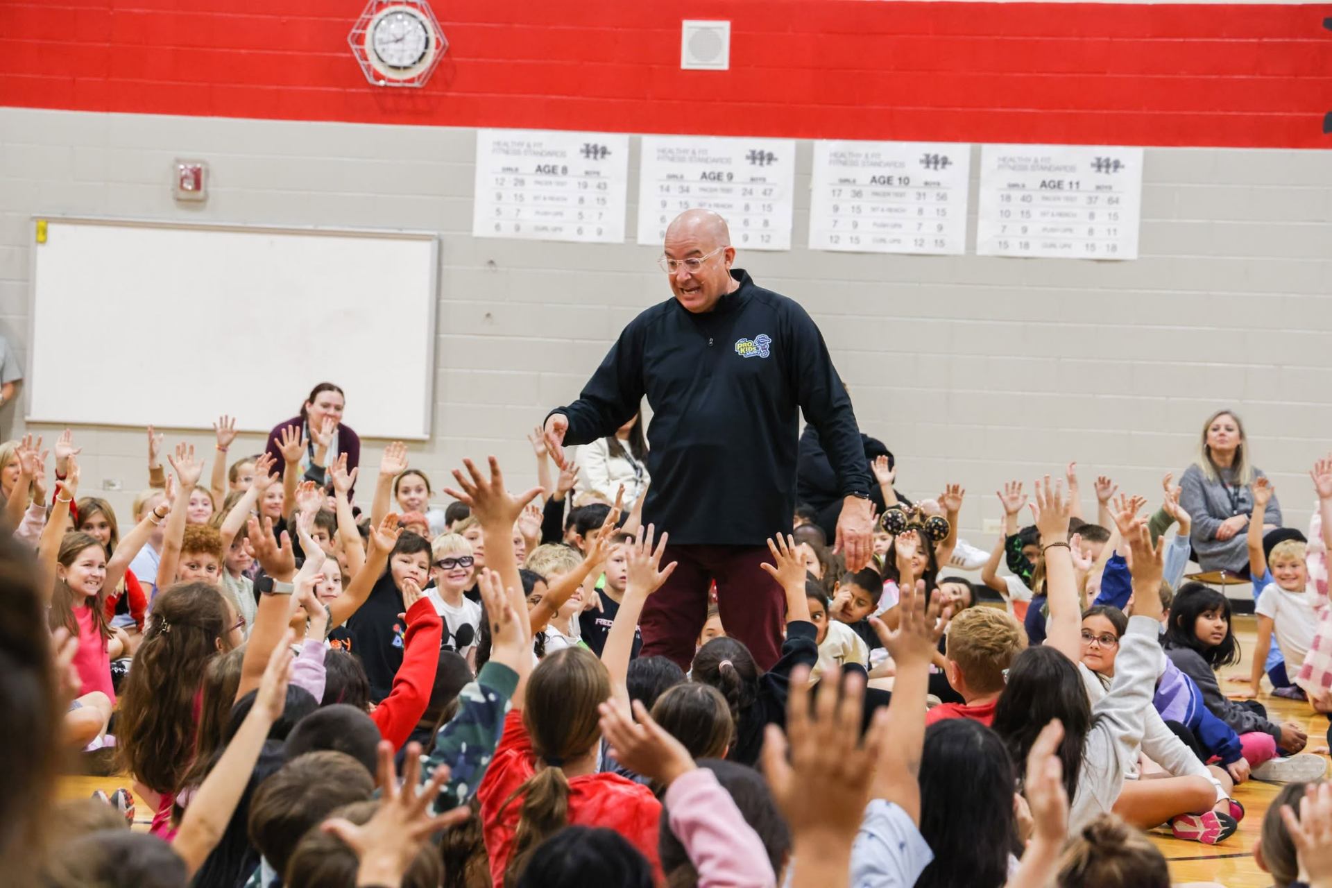 Tim in the middle of a packed crowd of students