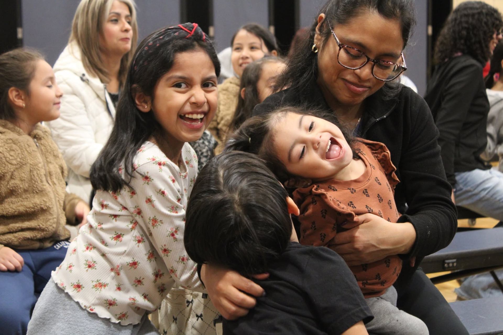 Parents laughing and enjoying the Family Night show with their kids