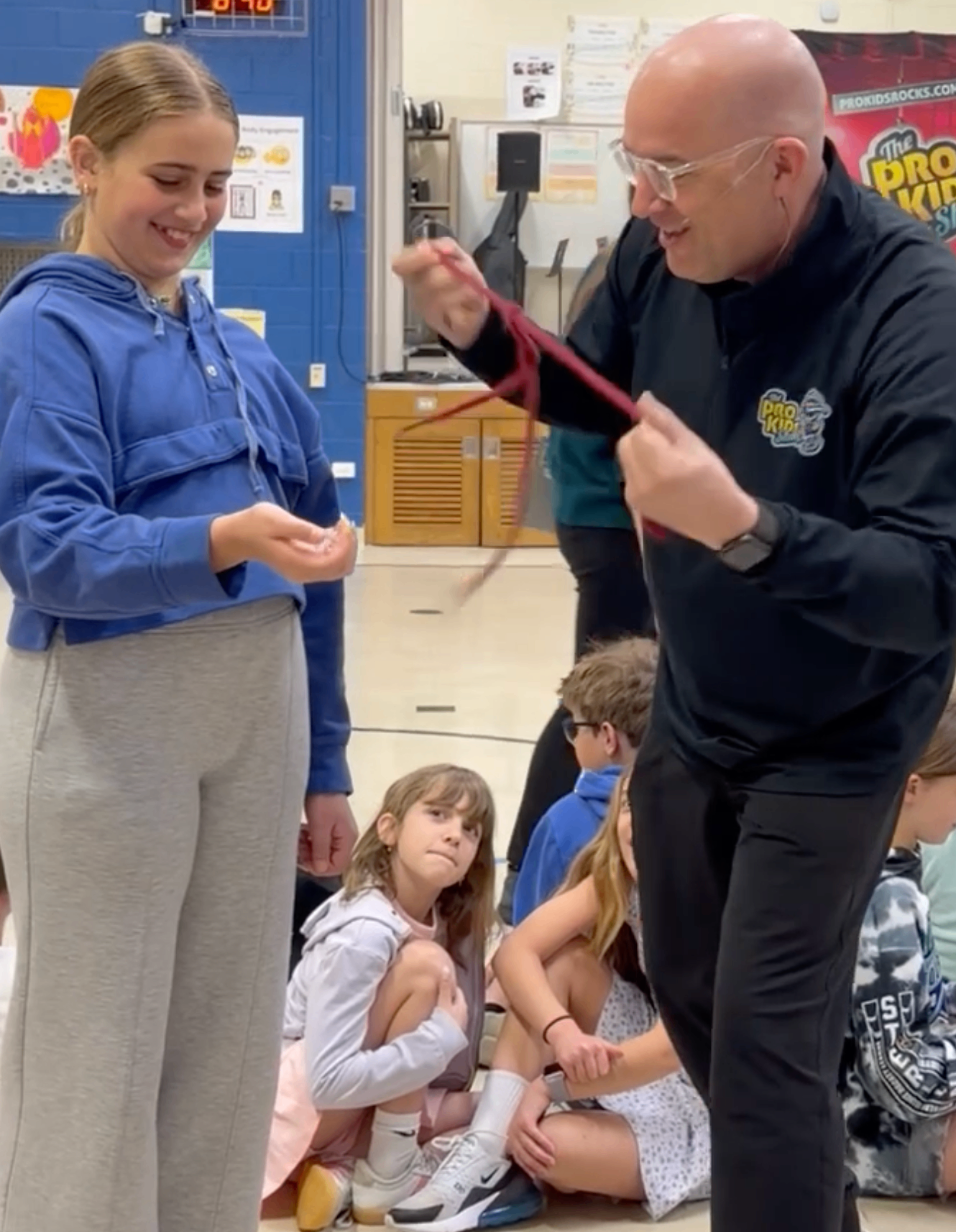 Tim doing close-up magic for 5th graders at Scott Elementary before the assembly