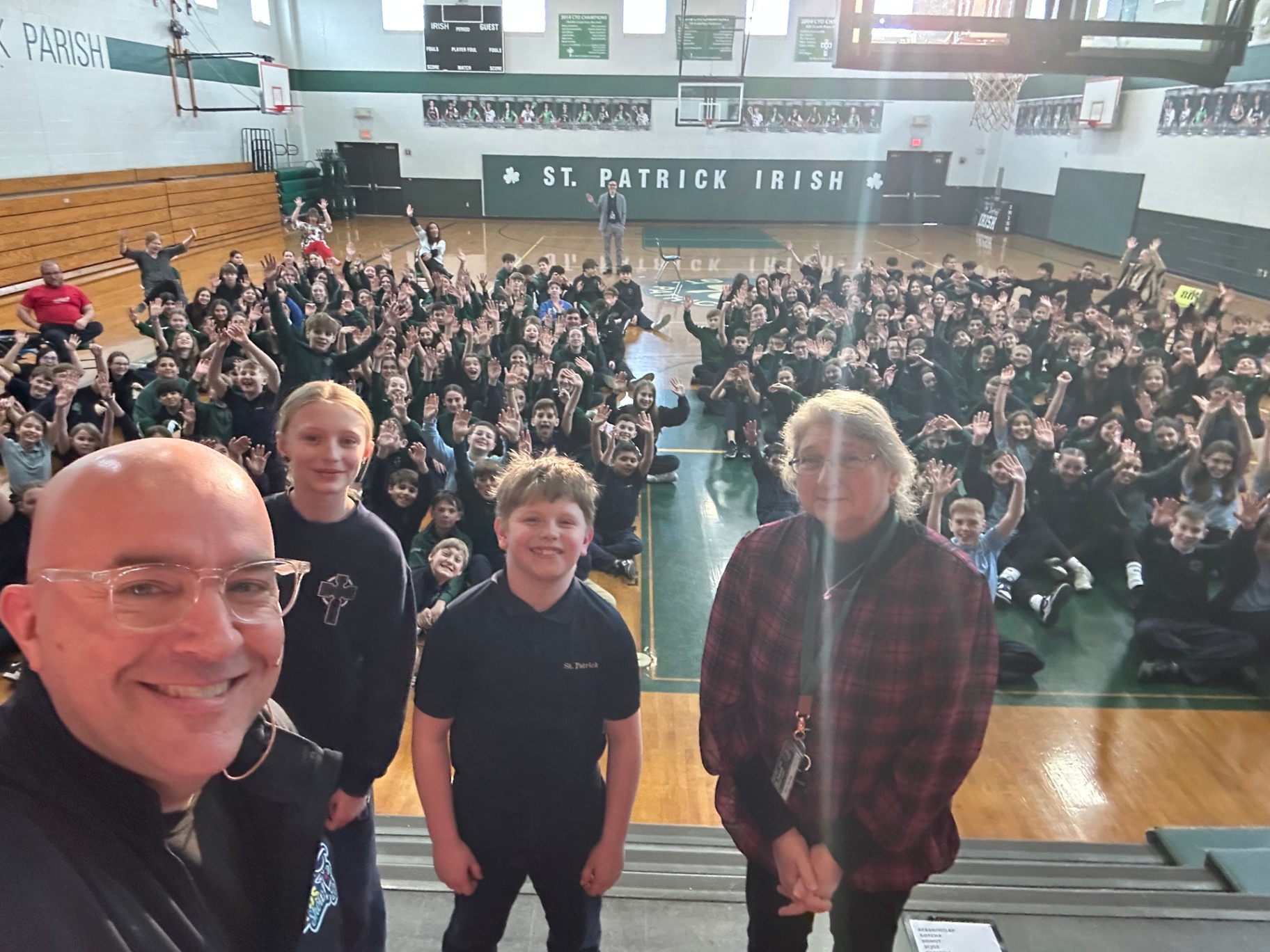 St. Patrick Catholic school students on the gym floor with Tim