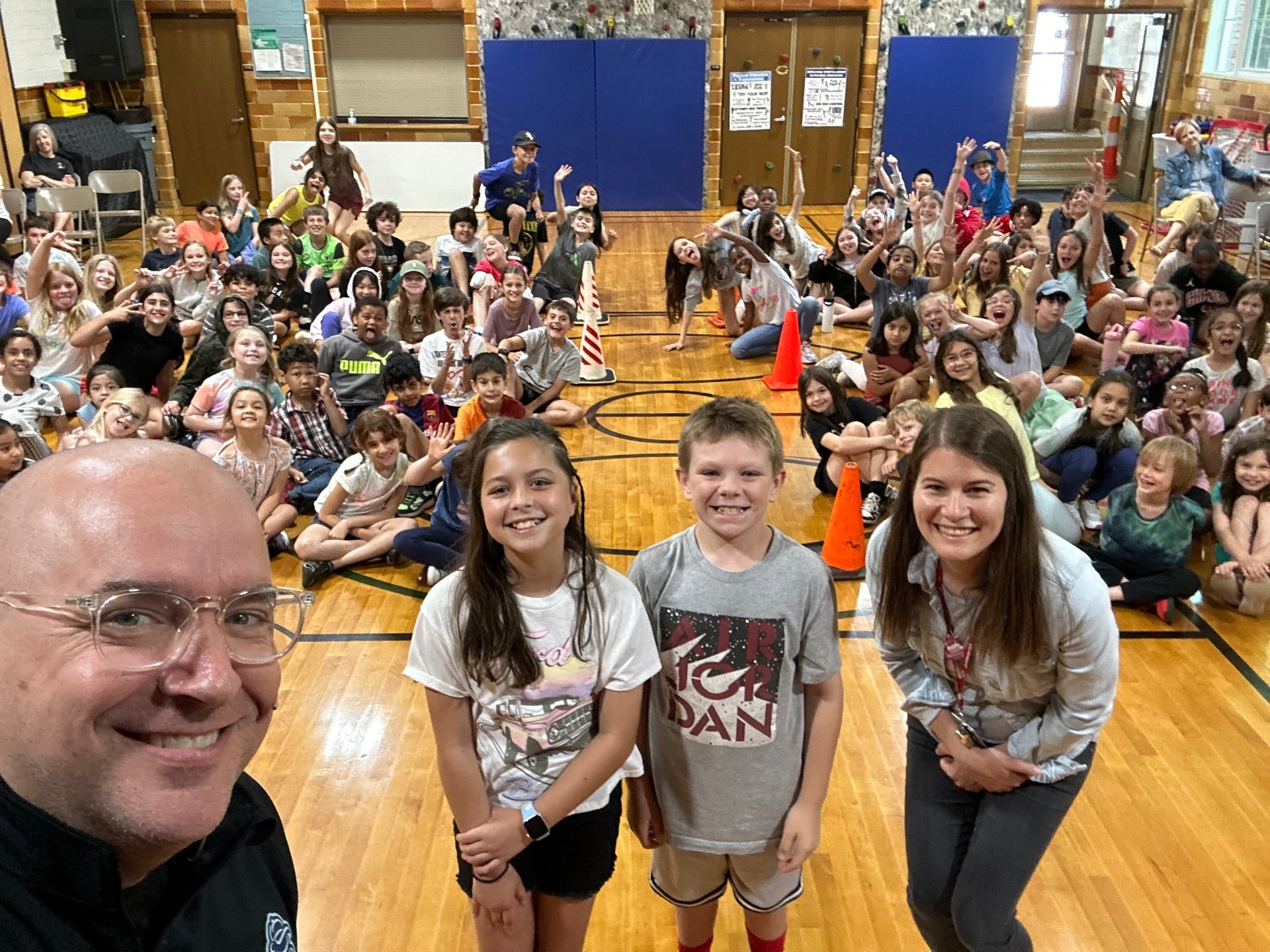 A large group photo with students after a Pro-Kids Show assembly at Ellsworth Elementary