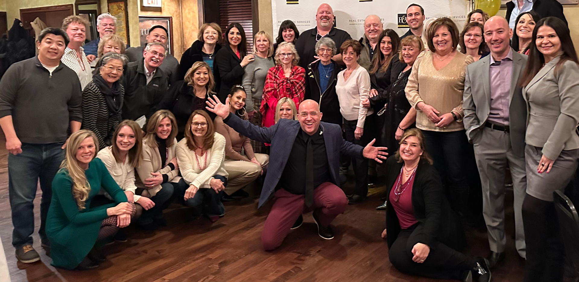 Tim posing with a large corporate team after a keynote
