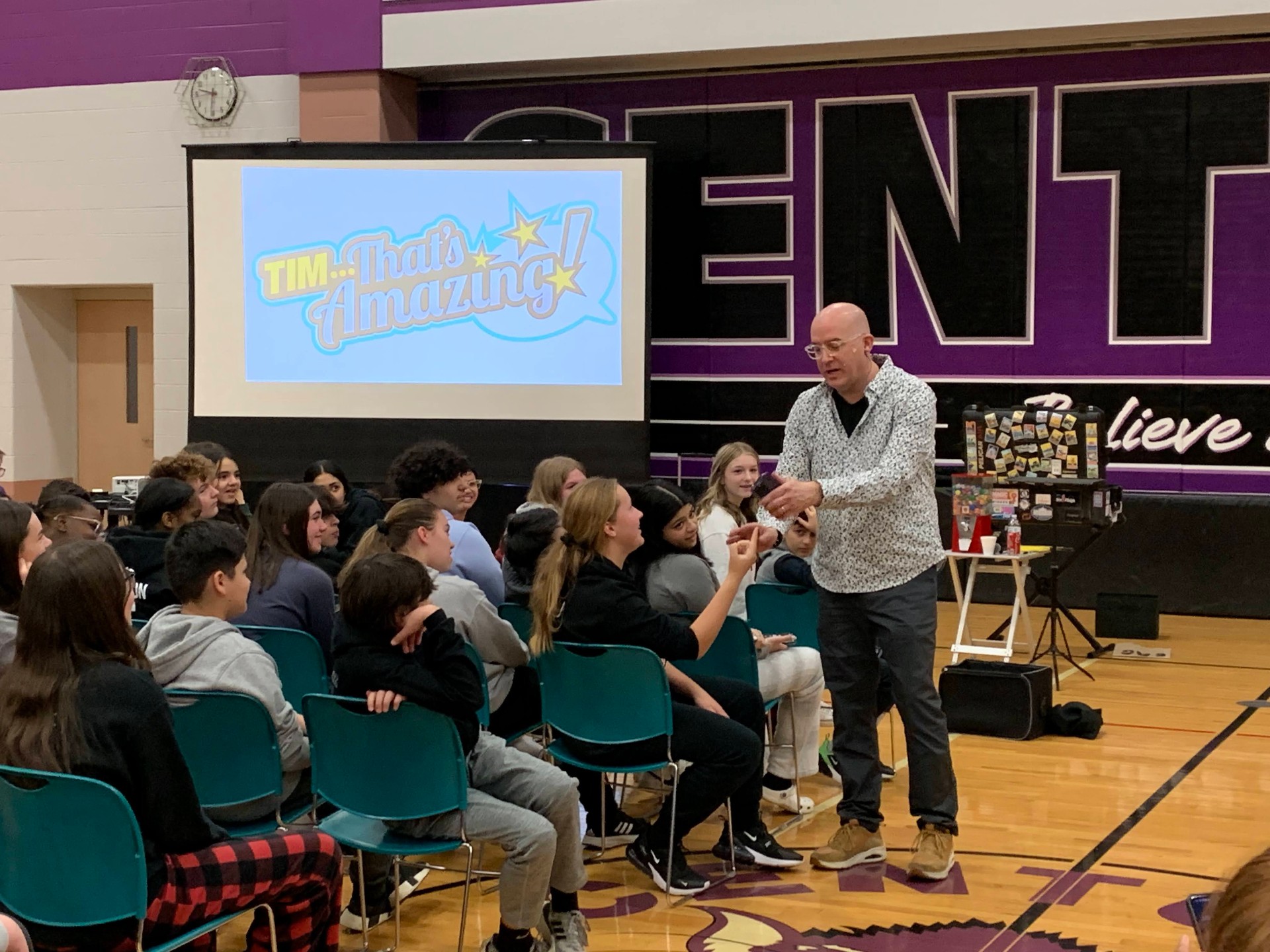Middle school volunteer helping with a cell phone mentalism routine